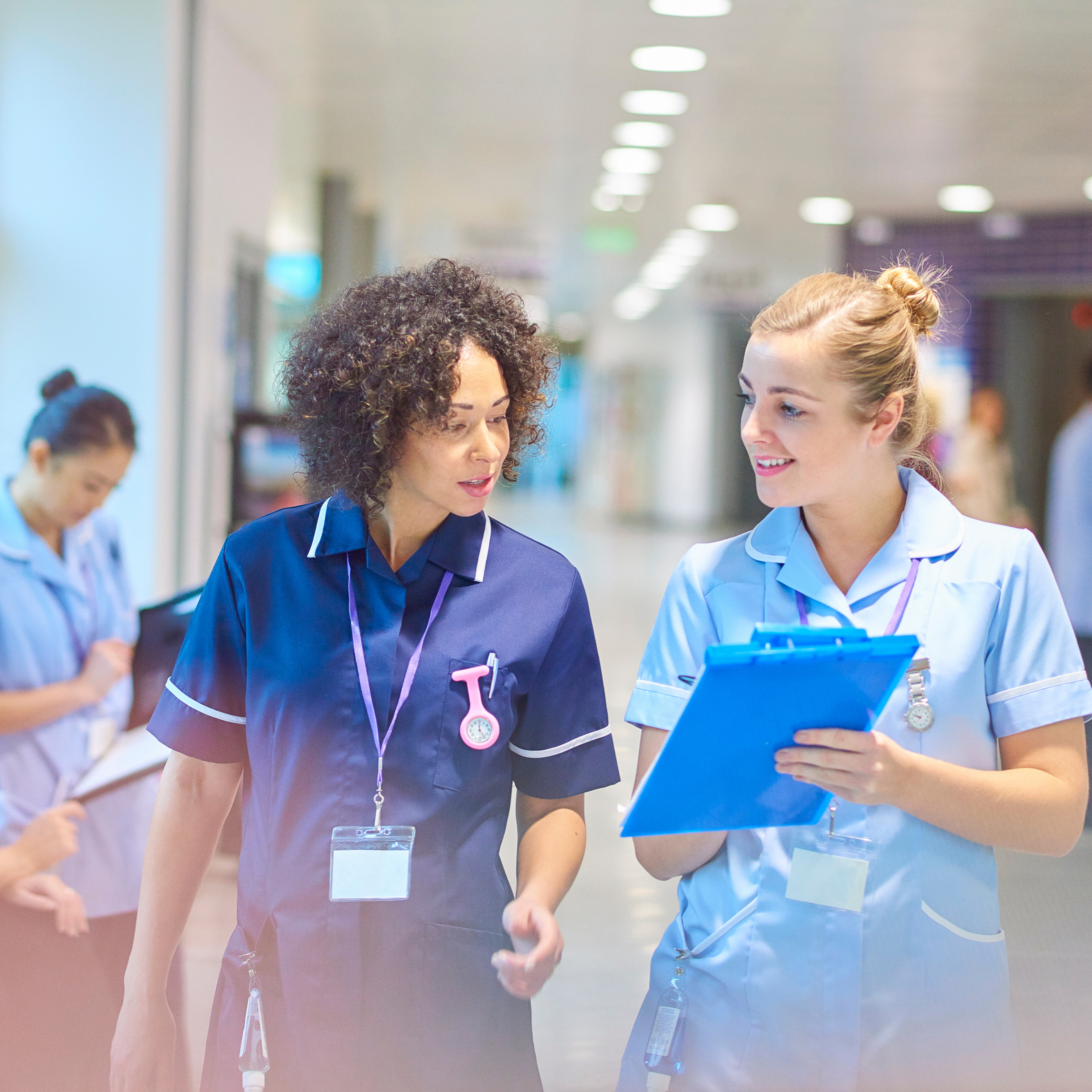 Female Doctors Walking and Having a Discussion 