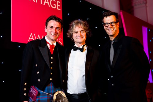 Thomas Elliott and Director of Heritage Chris Henry with awards host Marcus Brigstocke